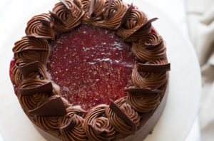 The Mad Hatter's Raspberry Fudge Cake filled with raspberry purée and dark chocolate ganache, with chocolate buttercream.