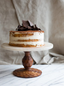 Mad Hatter's Tiramisu Cake on a wooden serving platter.