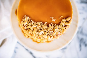 The Mad Hatter's Caramel Cake. Drizzled with homemade caramel. Topped with NC toasted peanuts.