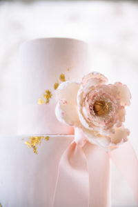 The Mad Hatter's Fairy Tale cake. With delicate peony blooms, pink frosting, and gold flecks and accents.