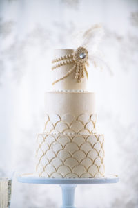 The Mad Hatter's Great Gatsby cake. With pearl accents, cream colored frosting, and scallop designs.