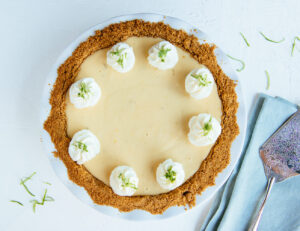 Delicious homemade key lime pie topped with whipped cream and lime zest, served at Mad Hatter Cafe & Bakeshop in Durham
