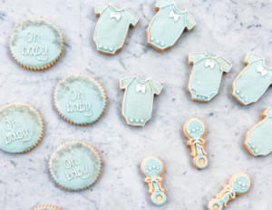 Baby shower cookies from Mad Hatter's Durham Bakery with "Oh baby" decorations